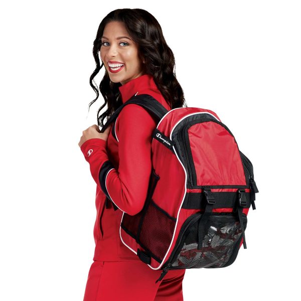 Smiling model in Champion Nova Warm Up Jacket with coordinating pants and back pack, back three-quarters view