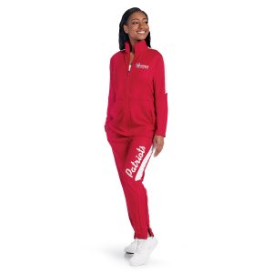 Smiling model wearing red/white Holloway Crosstown Warmup Jacket and Pants
