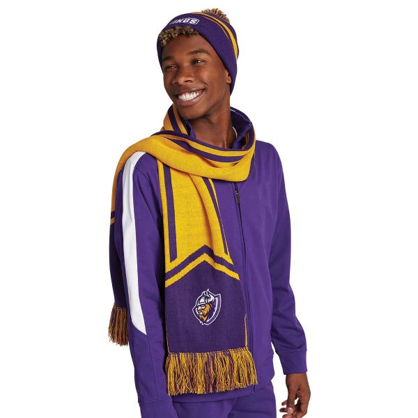 smiling model wearing a Holloway Homecoming Beanie with coordinating warmups and scarf, front three-quarters view