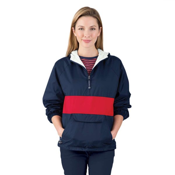 Female model posing with her hands in the front pocket of a red/navy Charles River Classic Striped Pullover, front view