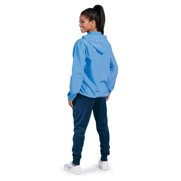 Smiling model wearing a light blue hooded Charles River Pack-N-Go Pullover, back three-quarters view