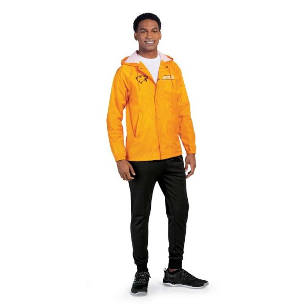 Model smiling in Pennant Performance Jogger Pants and a gold hooded jacket, front view