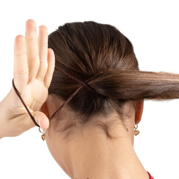 model putting a dark brown capezio bunheads hair tie in her hair