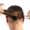 model putting a dark brown capezio bunheads hair tie in her hair