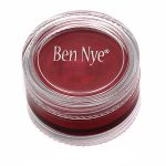 cherry red ben nye creme makeup in a clear compact