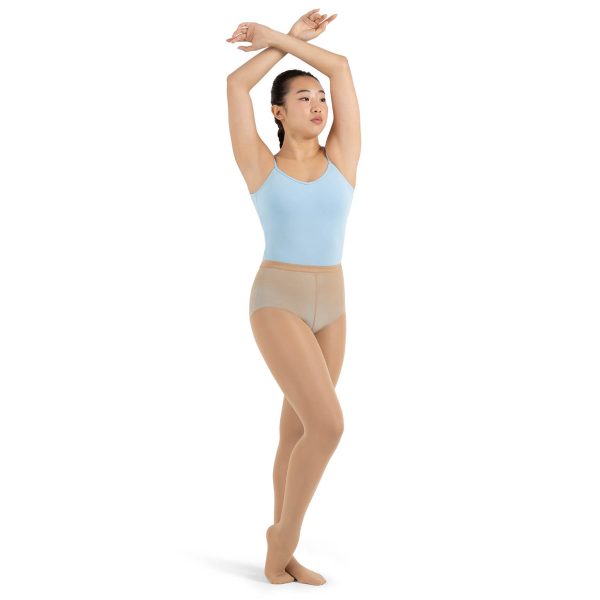 Model wearing caramel capezio hold and stretch footed tight, front three-quarters view