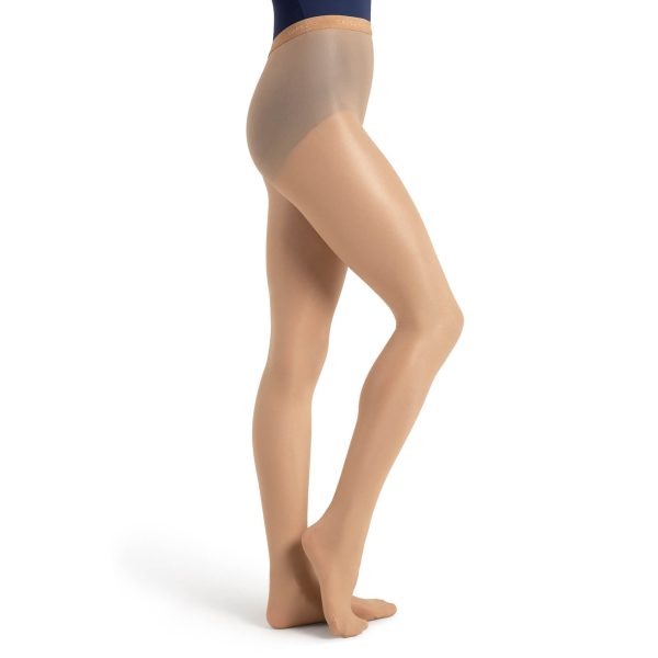 Model wearing caramel capezio ultra shimmery footed tight, side view