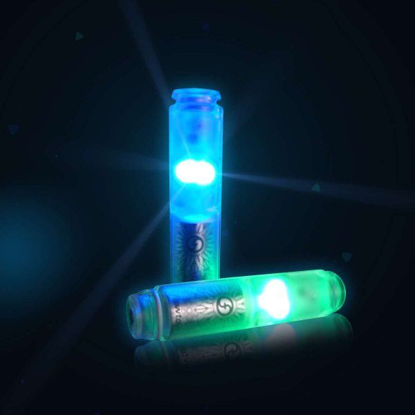 Lumina V2 Light Up Twirling Baton pods glowing in blue and green in a darkened space