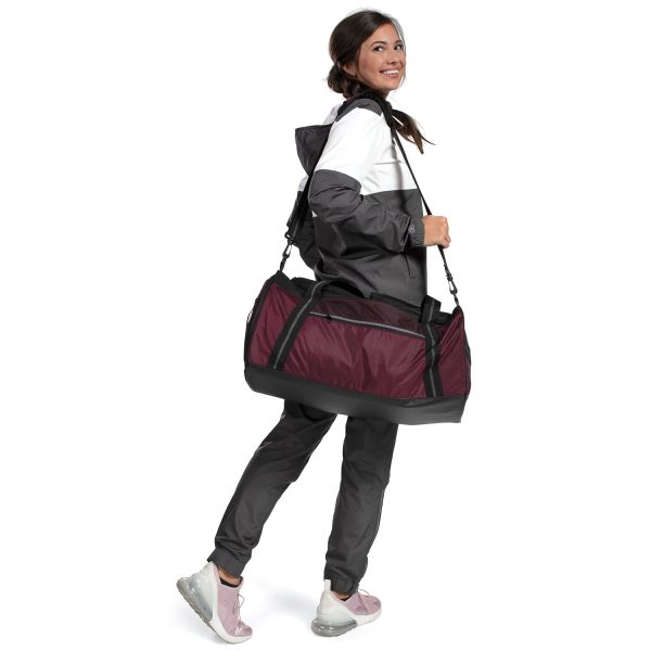 female model holding a Holloway Rivalry Duffel Bag looking over her shoulder
