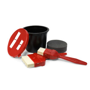 black chromark ink well with two red brushes, an ink well sponge, and a red two-slot lid