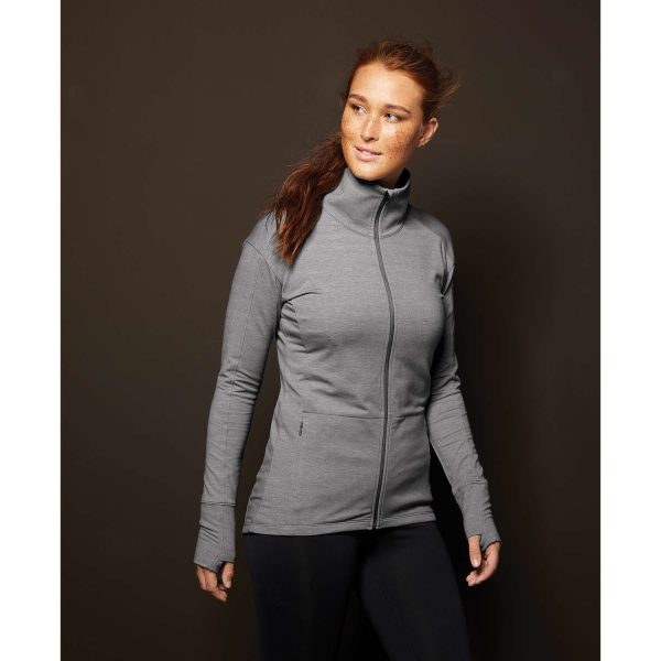 pretty model posing on a dark background wearing a grey Sport-Tek Sport-Wick Flex Fleece Jacket, front three-quarters view