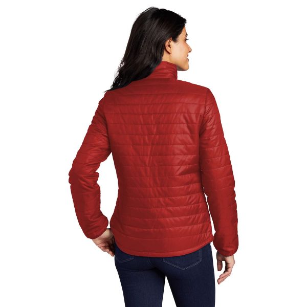 back view of a female model wearing Port Authority Packable Puffy Jacket