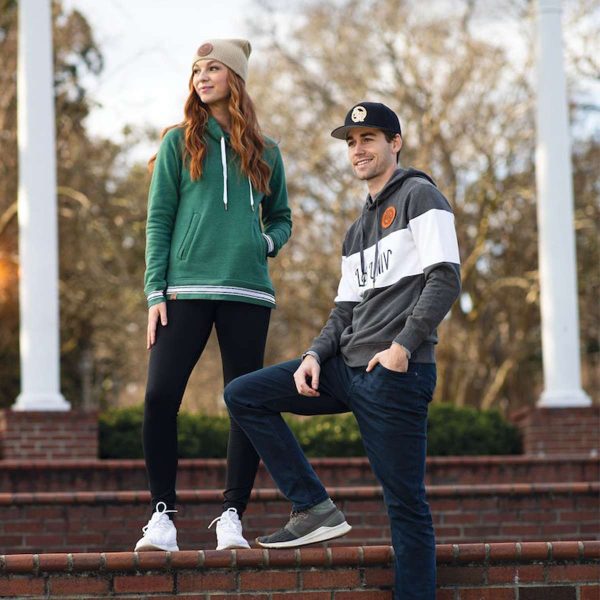 two people hanging out on a campus in the evening, one wearing a Carbon Heather All-American Hoodie