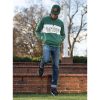 man hanging out on a campus in the evening wearing a Dark Green Heather Holloway All-American Pullover, head down