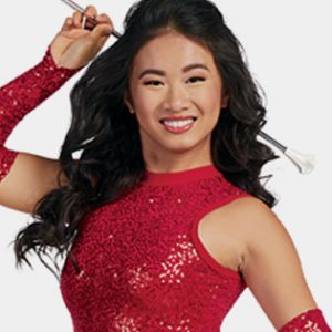 pretty young asian girl in a sequin uniforms holding a twirling baton.