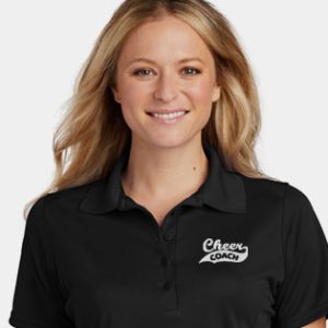 Caucasian woman in a black polo shirt.
